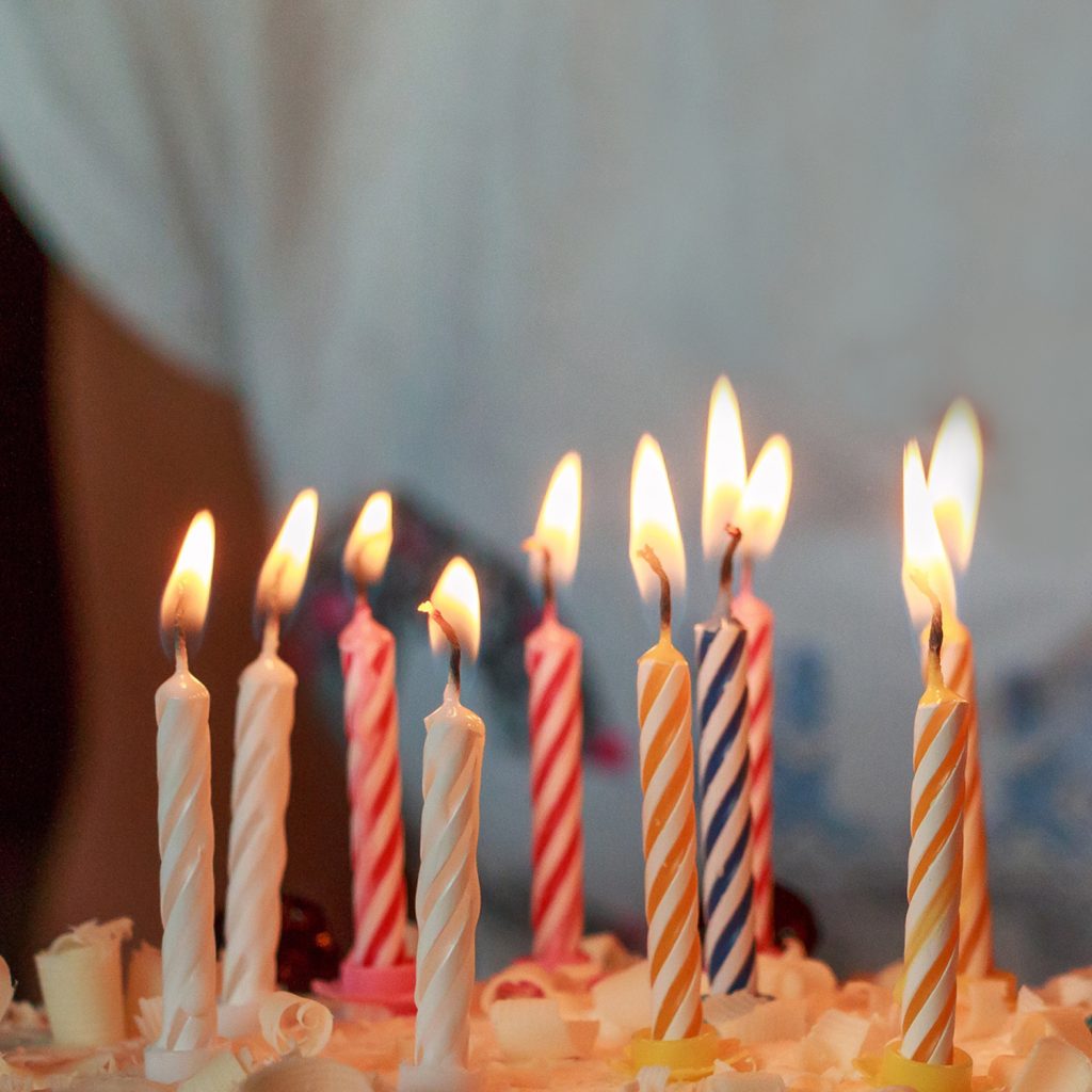 Photo, close up of candles on a birthday cake in support of facility rentals.