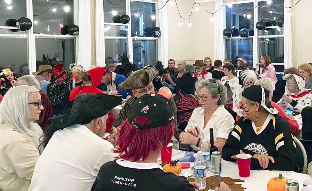 Photo of people in costumes dressed up for Halloween trivia night at the Seaside Centre.